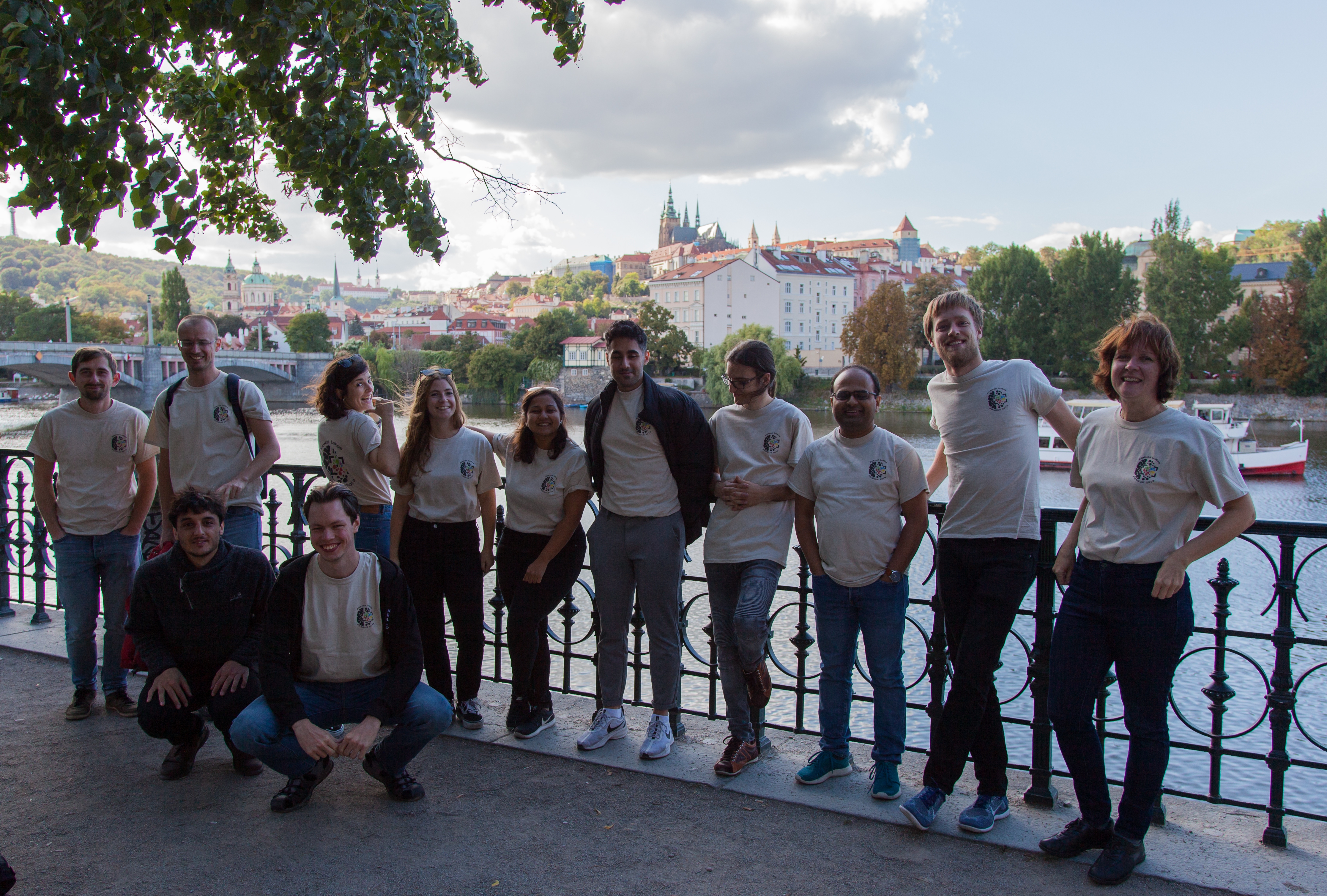 Image 1. Group photo on the Vltava river embankment. From left to right: Misha, Kostya, Berta, Andrea, Sushmita, Edmond, Norbert, Navneet, Rasmus, Irina. Sitting: Diego and Viktor.