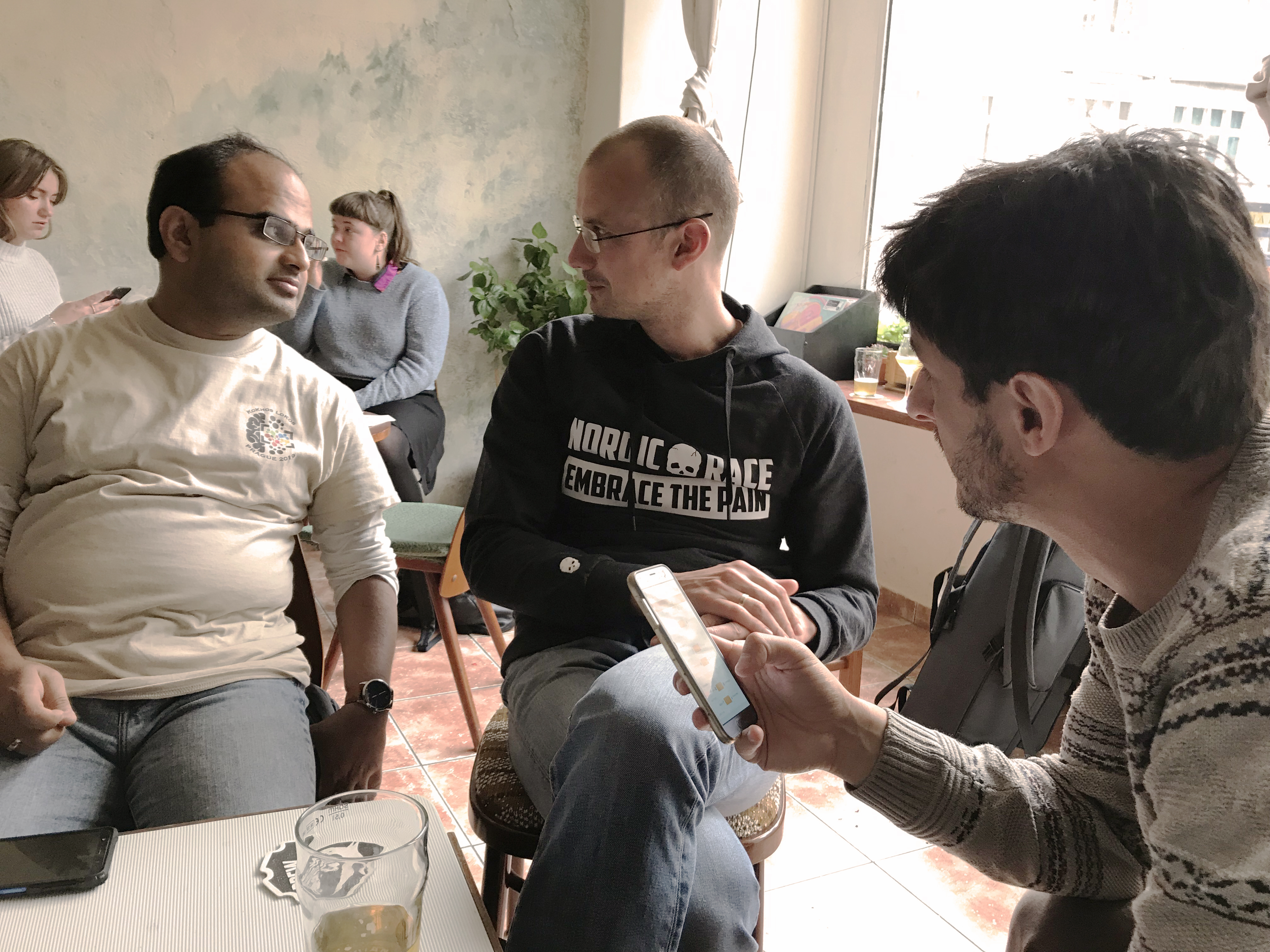Image 12. Navneet, Kostya and Diego chatting in a café.